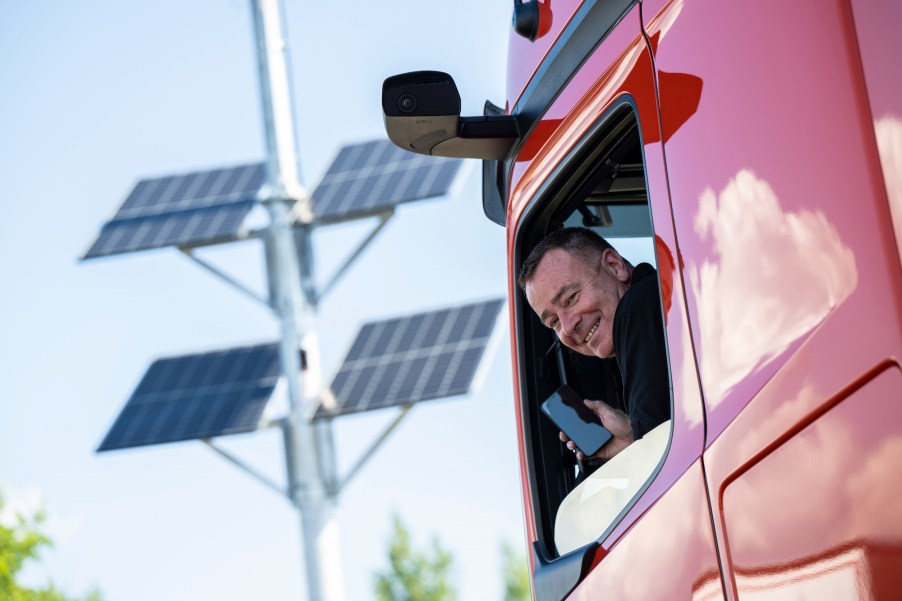 A truck driving sitting in his truck, showing people that truck drivers are important and vital to every day life.