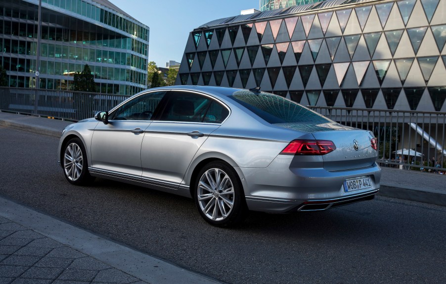 A silver Volkswagen Passat midsize sedan driving down a highway during the day