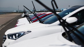 Windshield wipers sticking up on multiple cars in a row.