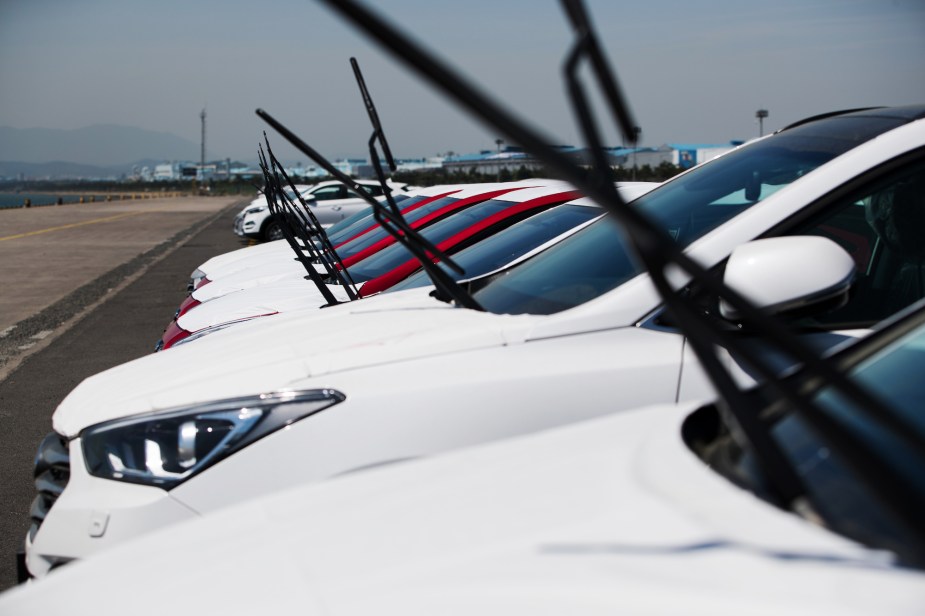 Windshield wipers sticking up on multiple cars in a row.