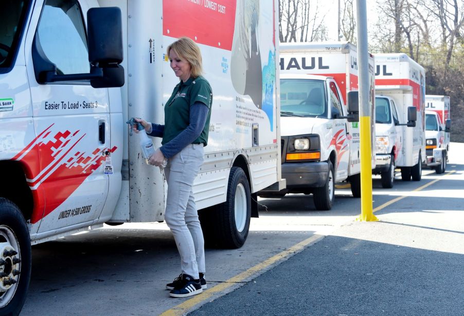 A lineup of U-Haul trucks being disinfected in Reading, Pennsylvania