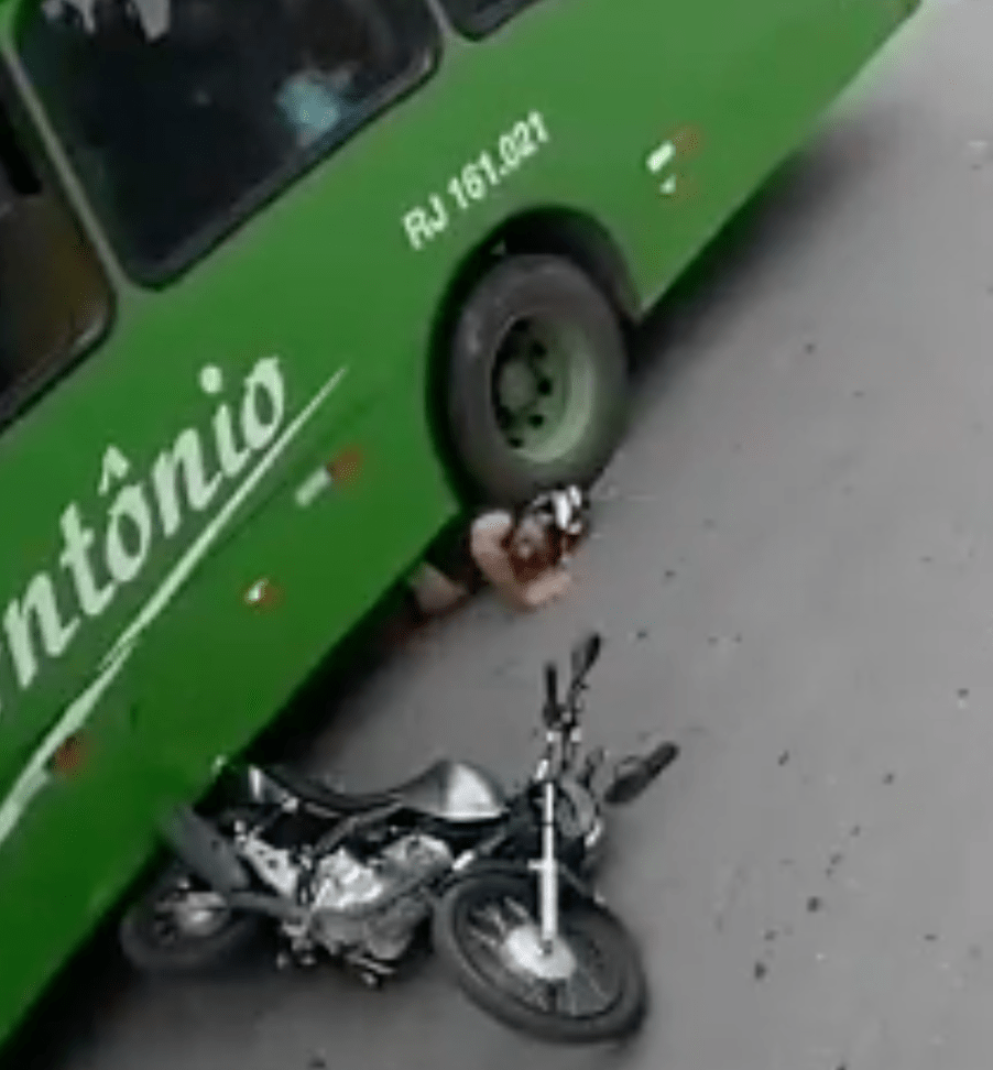 Motorcycle rider with his under a bus tire