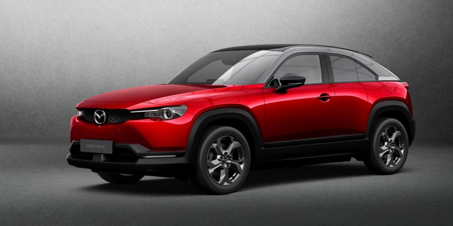 A promotional design shot of a red 2022 Mazda MX-30 electric SUV model