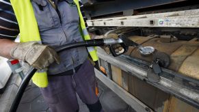 A trucker filling up the diesel tank on their vehicle in Berlin, Germany