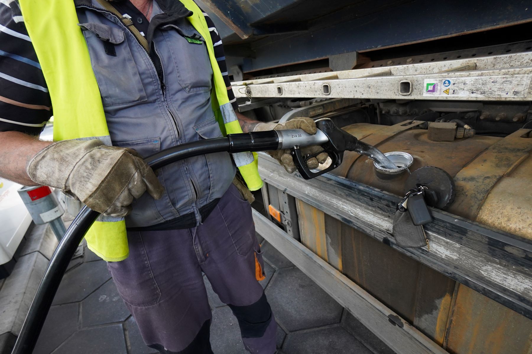 A trucker filling up the diesel tank on their vehicle in Berlin, Germany