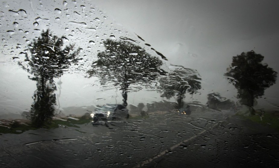 Water streaks on a windshield during a heavy rainfall.