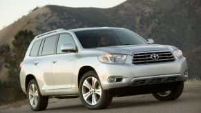 A silver gray 2008-2010 generation Toyota Highlander midsize SUV