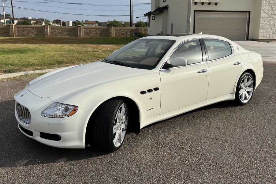 A used white 2010 Maserati Quattroporte S on a city street