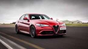 A red 2017 Alfa Romeo Giulia driving along a street