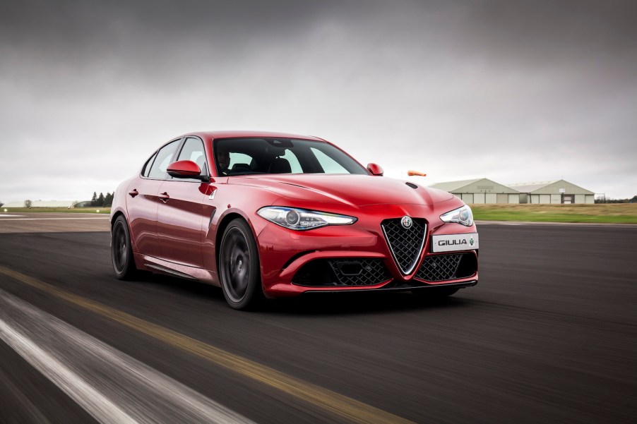 A red 2017 Alfa Romeo Giulia driving along a street