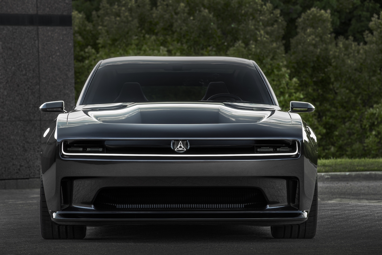 The front of the Charger Daytona SRT concept car with trees visible in the background.