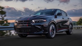 The Dodge Hornet GLH concept muscle CUV driving down a rural road at sunset.