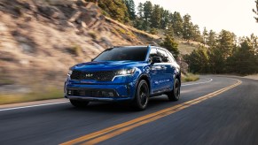 A blue 2022 Kia Sorento SX driving on a highway