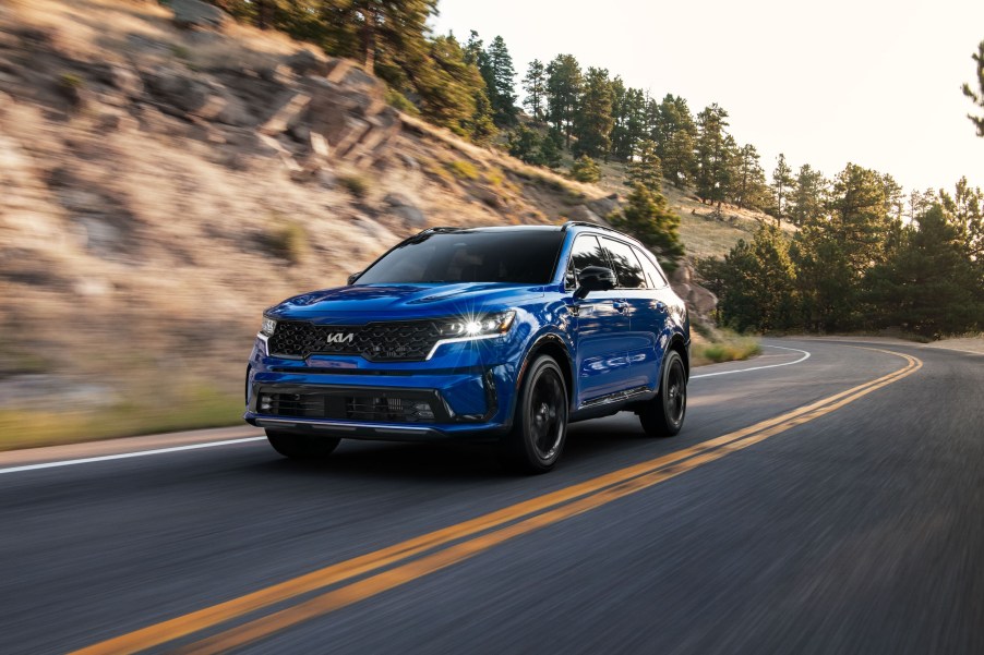 A blue 2022 Kia Sorento SX driving on a highway