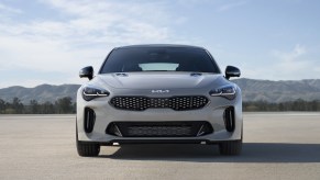 A gray Kia Stinger shows off its subtly styled front end.