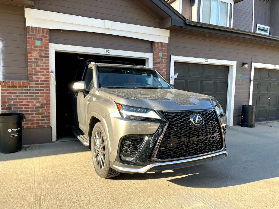 The 2022 Lexus LX 600 parked halfway into a garage.