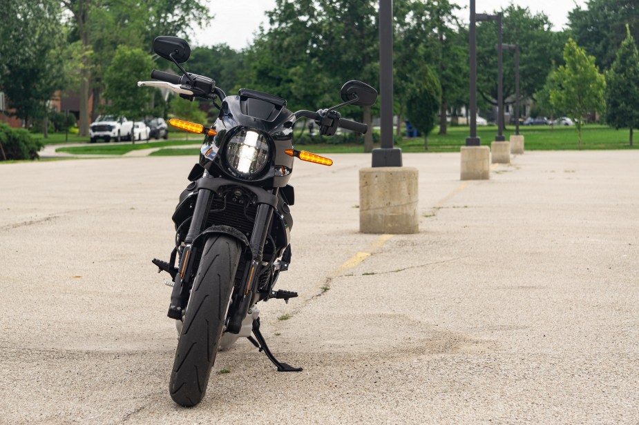 The front view of a black 2022 LiveWire One in a suburban parking lot