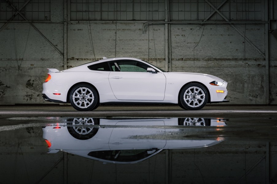 A white 2022 Ford Mustang parked in a warehouse