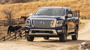 Blue 2022 Nissan Titan being used on a ranch