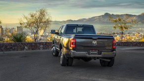 A gray Ram heavy-duty pickup truck parked overlooking a city.