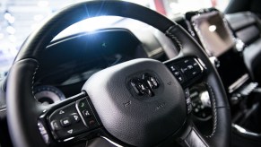 The steering wheel and infotainment screen of a Ram pick up truck.