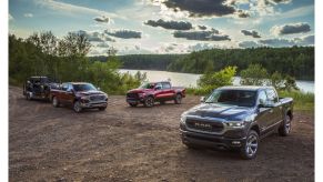 three 2022 ram trucks by a lake