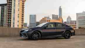 A Black 2022 Toyota Camry parked in an industrial setting