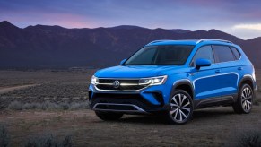 a blue VW Taos near mountains.