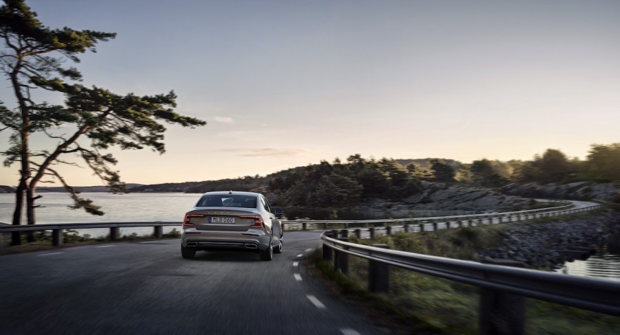 2022 Volvo S60 driving down a road.