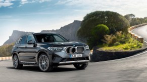 a gray BMW x3 on a twisty road