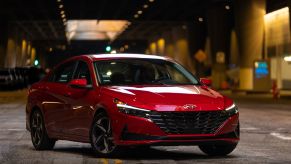 A red 2023 Hyundai Elantra compact sedan parked underground