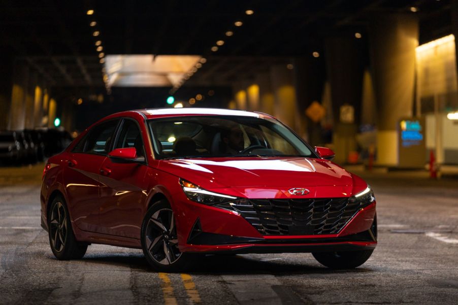 A red 2023 Hyundai Elantra compact sedan parked underground