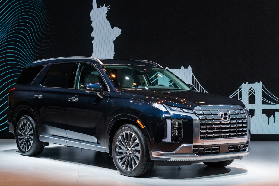 A dark colored 2023 Hyundai Palisade parked indoors. 