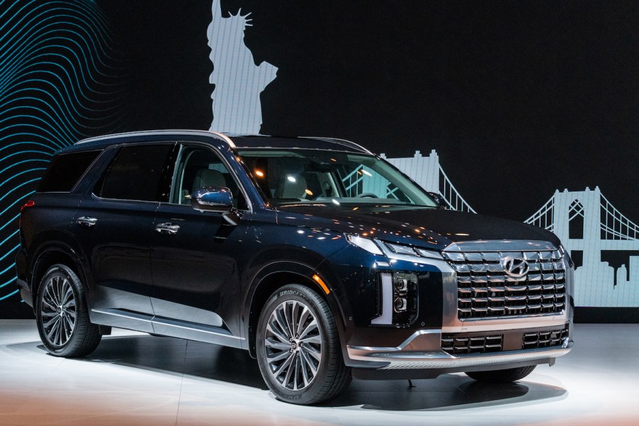 A dark colored 2023 Hyundai Palisade parked indoors.