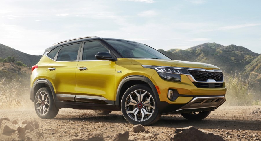 A yellow 2023 Kia Seltos subcompact SUV is parked outdoors.