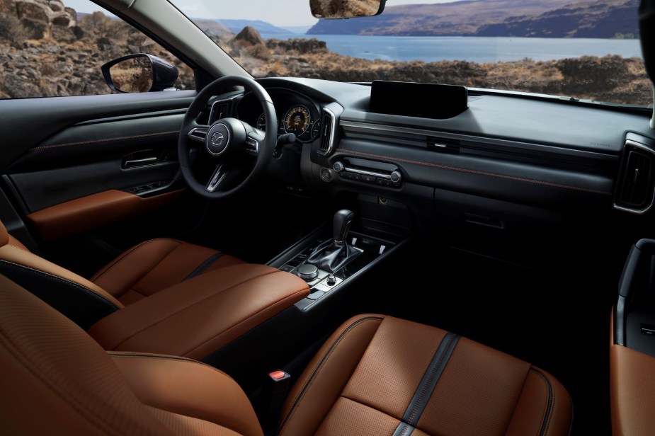 A view of the 2023 Mazda CX-50 cabin interior front seating and dashboard