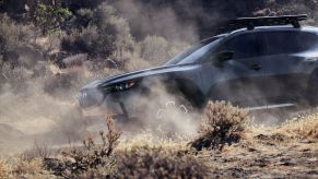 A 2023 Mazda CX-50 covered in desert dust from driving on an off-road trail