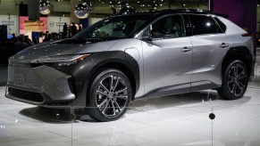 A silver and black 2023 Toyota bZ4X parked indoors.