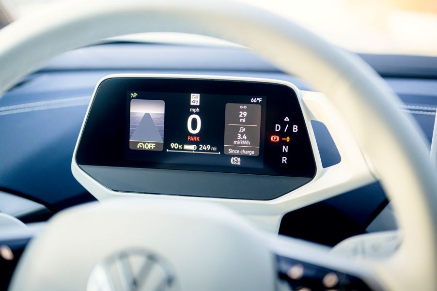 The driver's display behind a steering wheel of a 2023 Volkswagen ID. 4 all-electric SUV (EV) model