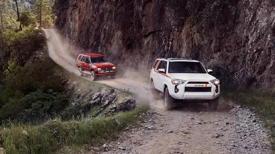 A white 2023 Toyota 4Runner followed by a 1983 4Runner.