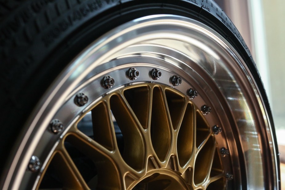 A close up of gold aftermarket wheels, aftermarket wheels do not increase a car's trade in value