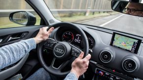 A front view of a driver driving an Audi TT.