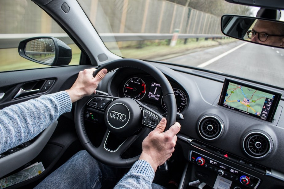 A front view of a driver driving an Audi TT.