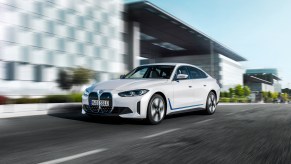 A white 2023 BMW i4 EV driving