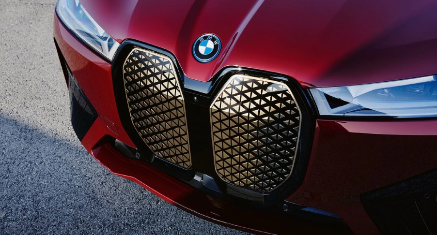 The front of a red BMW iX luxury electric midsize SUV.