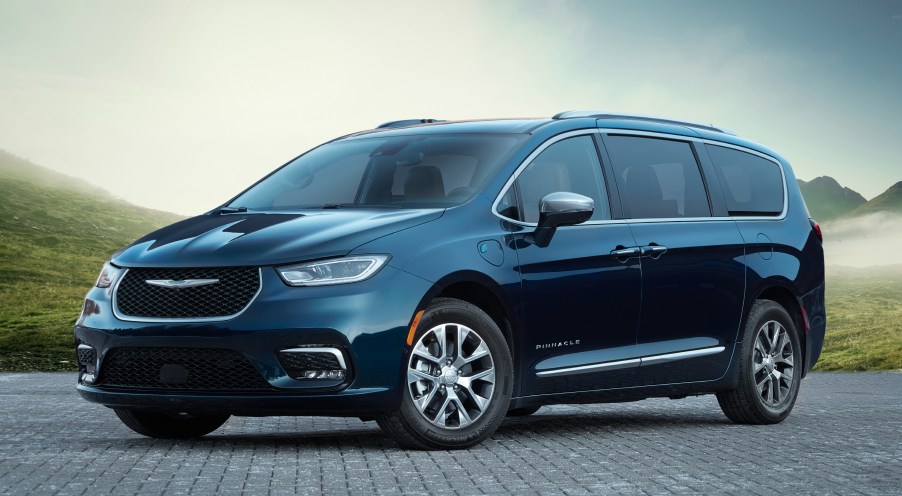 a dark blue Chrysler Pacifica parked on cobbles