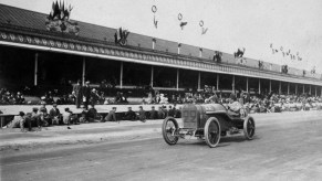 A Peugeot race car on a dirt track winning the French Grand Prix with the world's first DOHC engine.