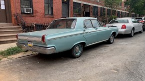 Aqua colored Dodge 440 classic car in the city.