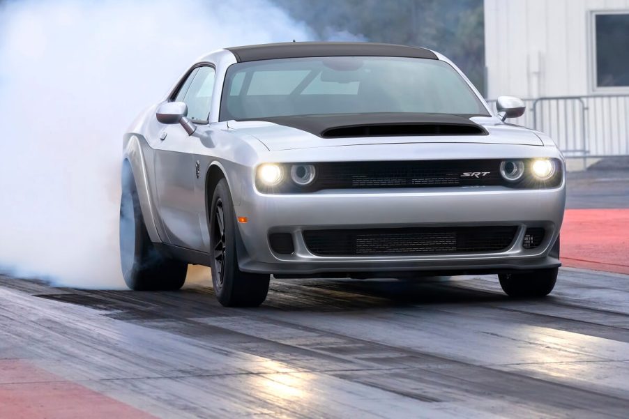 A 2023 Dodge Challenger SRT Demon 170 does a burnout at a drag strip.