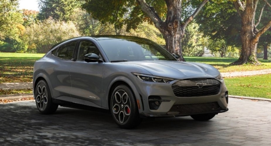 A gray Ford Mustang Mach-E electric SUV is parked. 